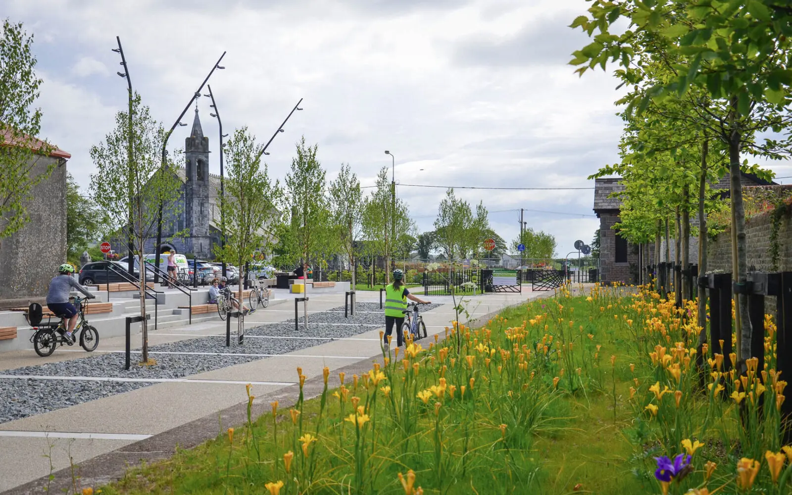 Integrated public realm featuring active mobility routes, structured tree planting, species-rich borders, and flexible gathering spaces that strengthen ecological and social connections within the village centre.